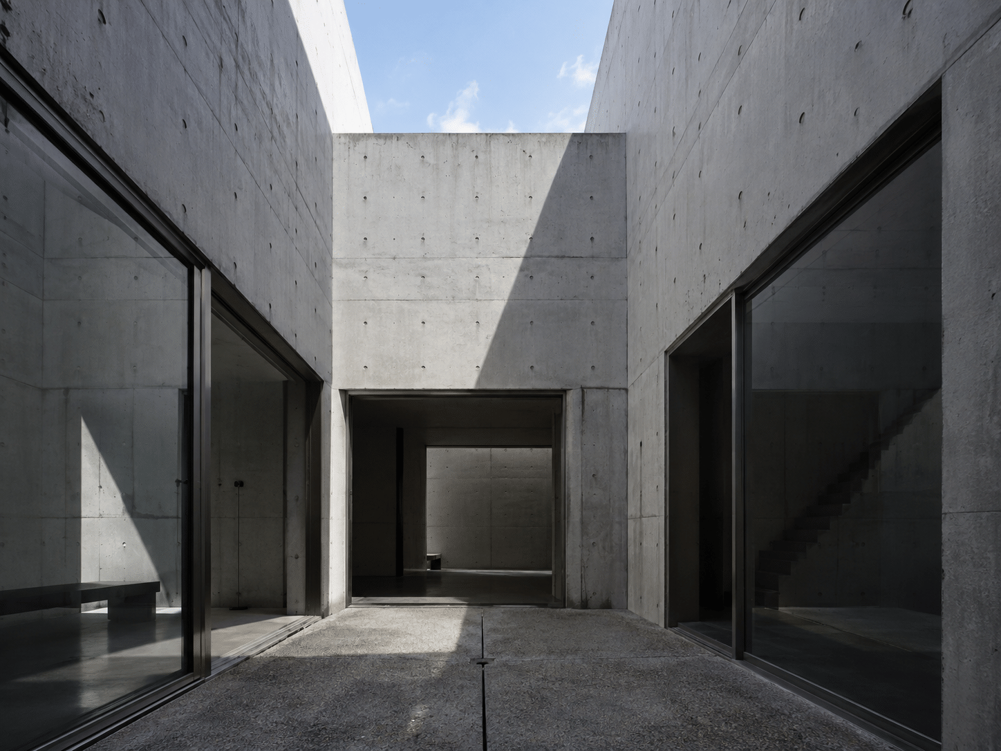 AI-generated editorial illustration evoking the concrete courtyard, light and shadow of Tadao Ando’s Azuma House in Osaka.