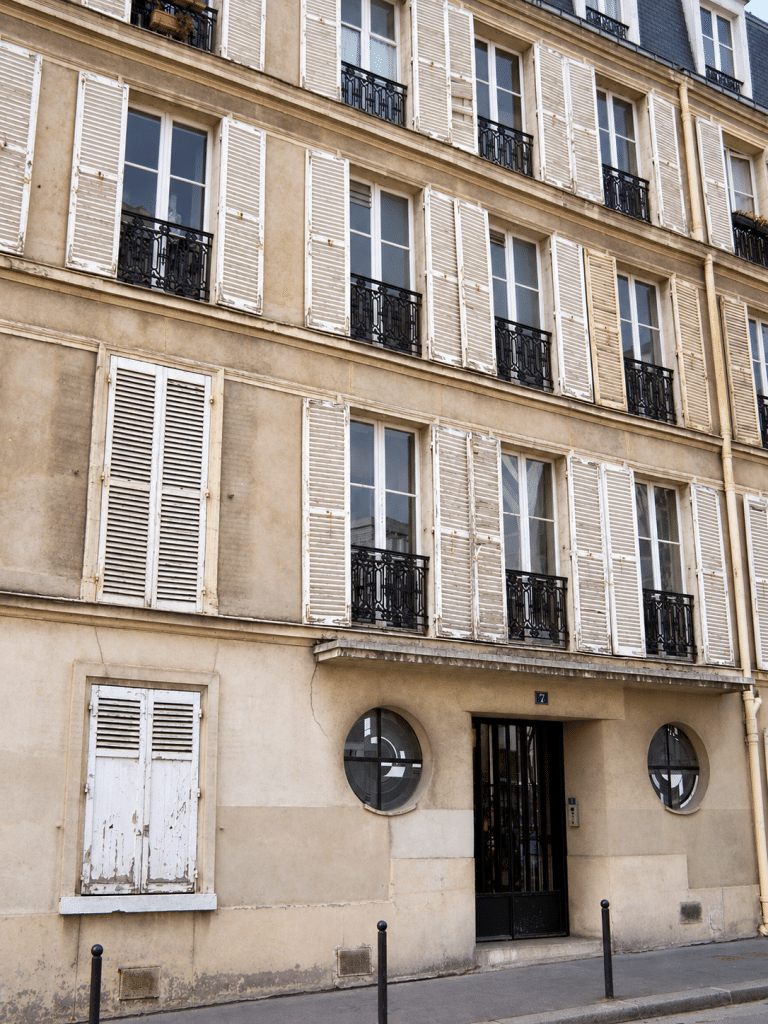 Street façade at 7 rue Méchain, Paris, in an AI-assisted editorial treatment of the original photograph
